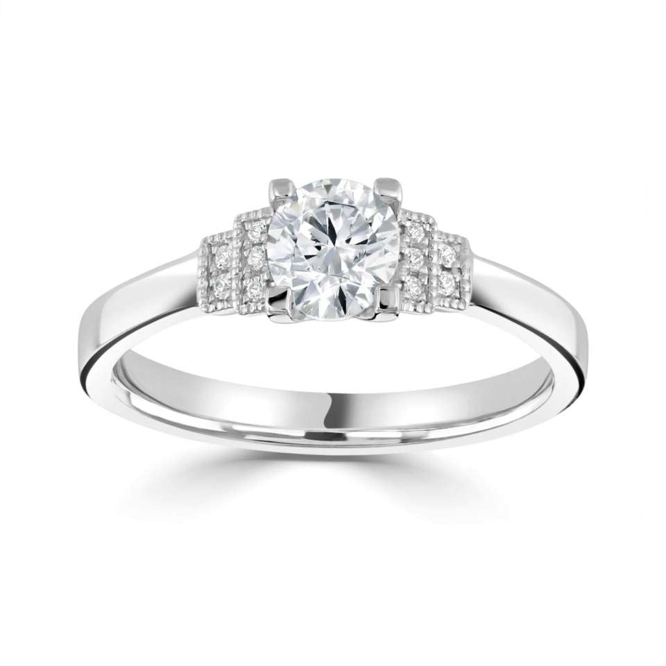 The Cornflower Platinum Round Brilliant Cut Diamond Solitaire Engagement Ring With Diamond Set Shoulders
