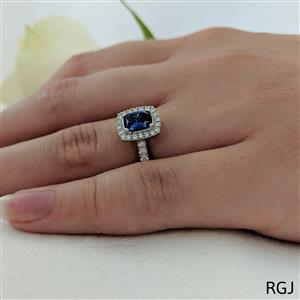 The Skye Platinum 0.67ct Cushion Cut Blue Sapphire Ring With 0.36ct Diamond Halo And Diamond Set Shoulders