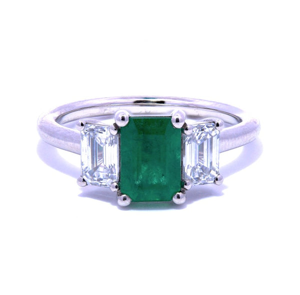 platinum 0.95ct emerald cut emerald and 0.60ct emerald cut diamond three stone ring