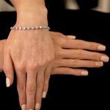 18ct white gold round brilliant cut diamond bar set bracelet model shot crossed hands