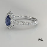 The Faroe Platinum 1.10ct Pear Cut Blue Sapphire Ring With 0.41ct Diamond Halo And Diamond Set Shoulders