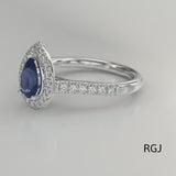 The Skye Platinum 0.76ct Pear Cut Blue Sapphire Ring With 0.33ct Diamond Halo And Diamond Set Shoulders