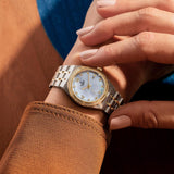 tudor royal 28mm mother of pearl diamond dot dial gold diamond bezel and steel on gold and steel bracelet automatic watch lifestyle image