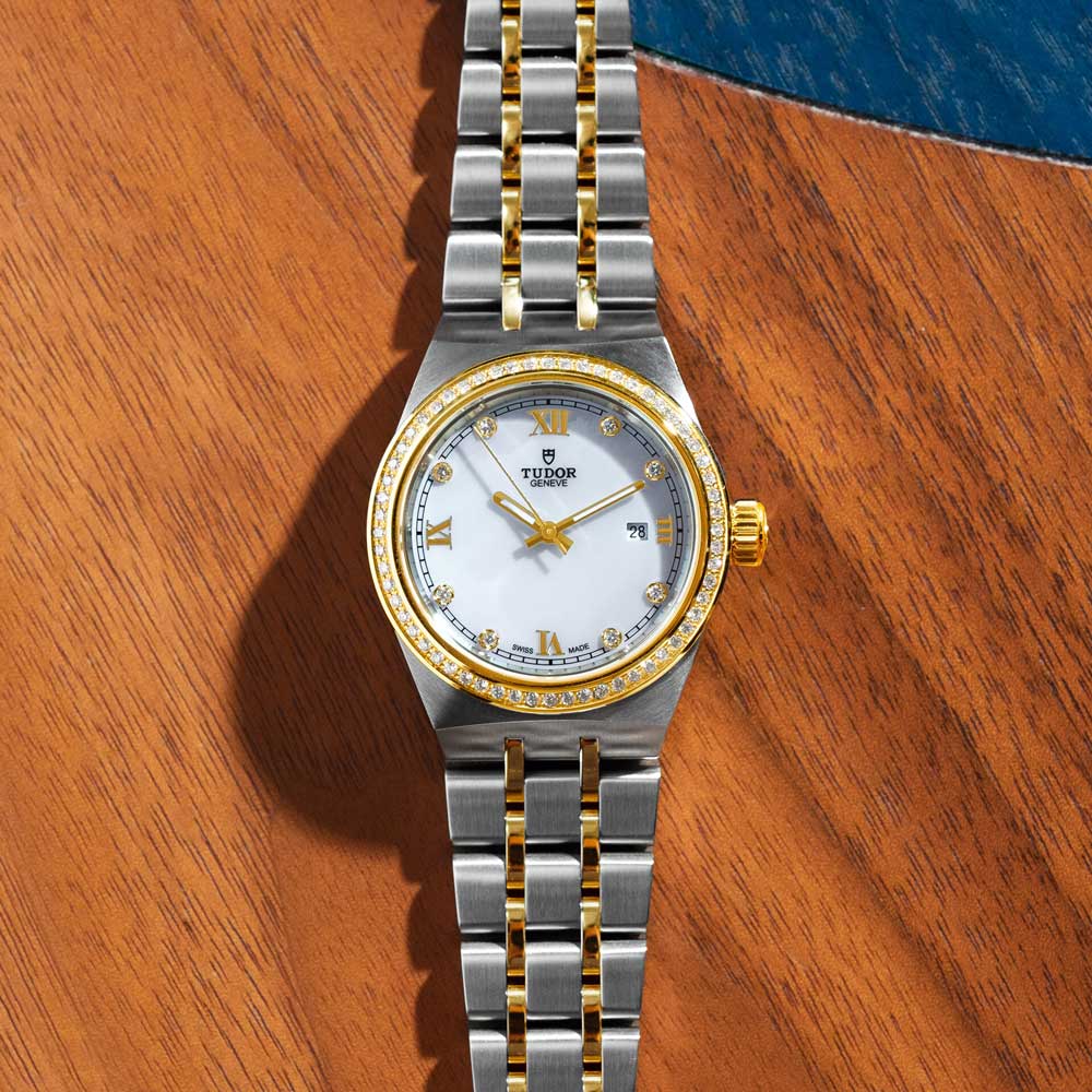 tudor royal 28mm mother of pearl diamond dot dial gold diamond bezel and steel on gold and steel bracelet automatic watch lifestyle image