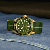 tudor black bay 58 18K 39mm green dial gold on fabric strap automatic watch showing its complimentary green fabric strap