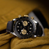 tudor black bay chrono s&g 41mm black dial gold and steel on leather strap automatic chronograph watch lifestyle image