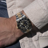 tudor black bay s&g 41mm black dial automatic gold and steel on gold and steel bracelet watch lifestyle image