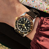 tudor black bay gmt s&g 41mm black dial gold and steel on leather strap automatic watch lifestyle image