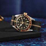 tudor black bay gmt s&g 41mm black dial gold and steel on fabric strap automatic watch lifestyle image