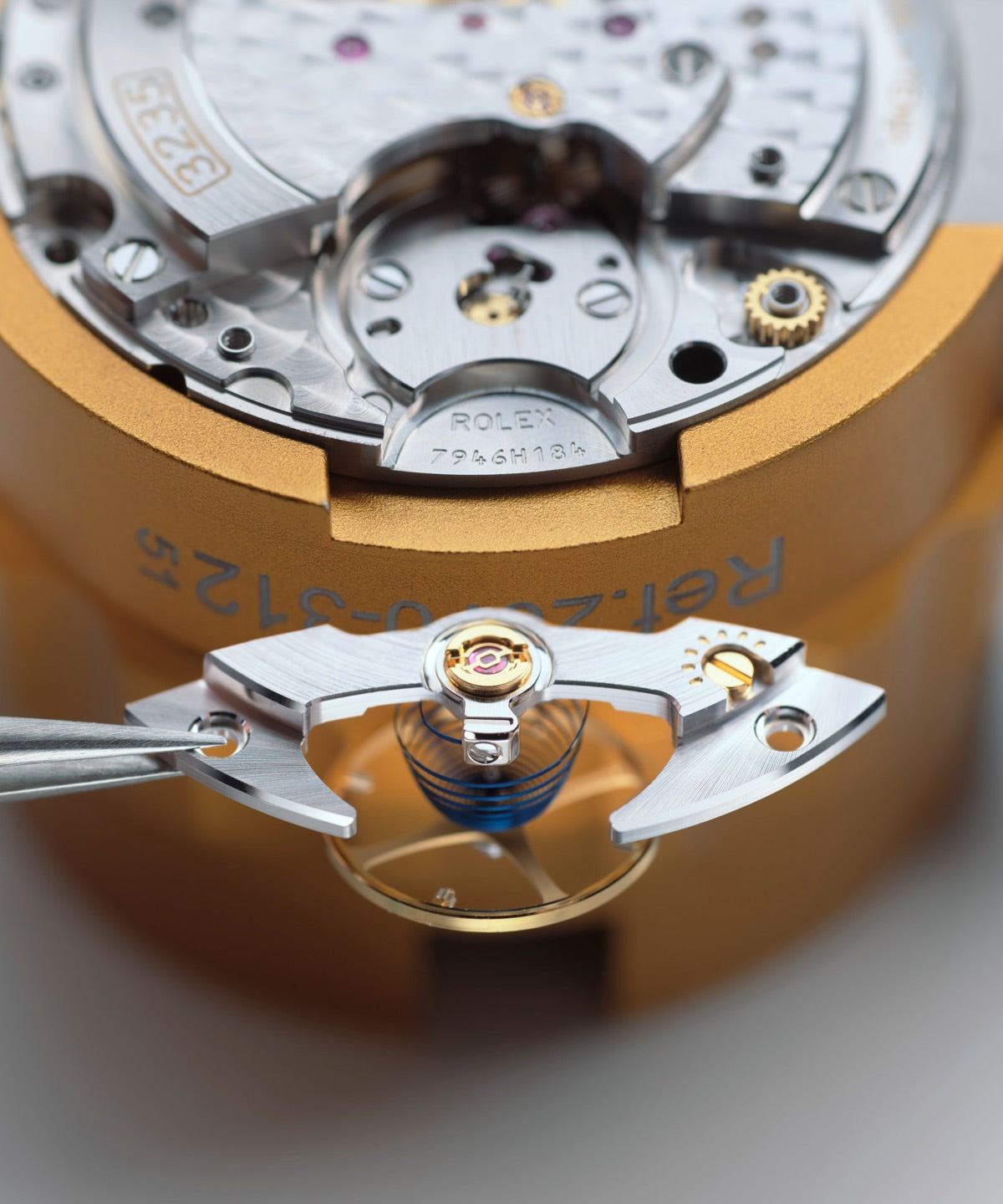 Close‑up image of a watchmaker reassembling the movement, carefully fitting cleaned components back into place