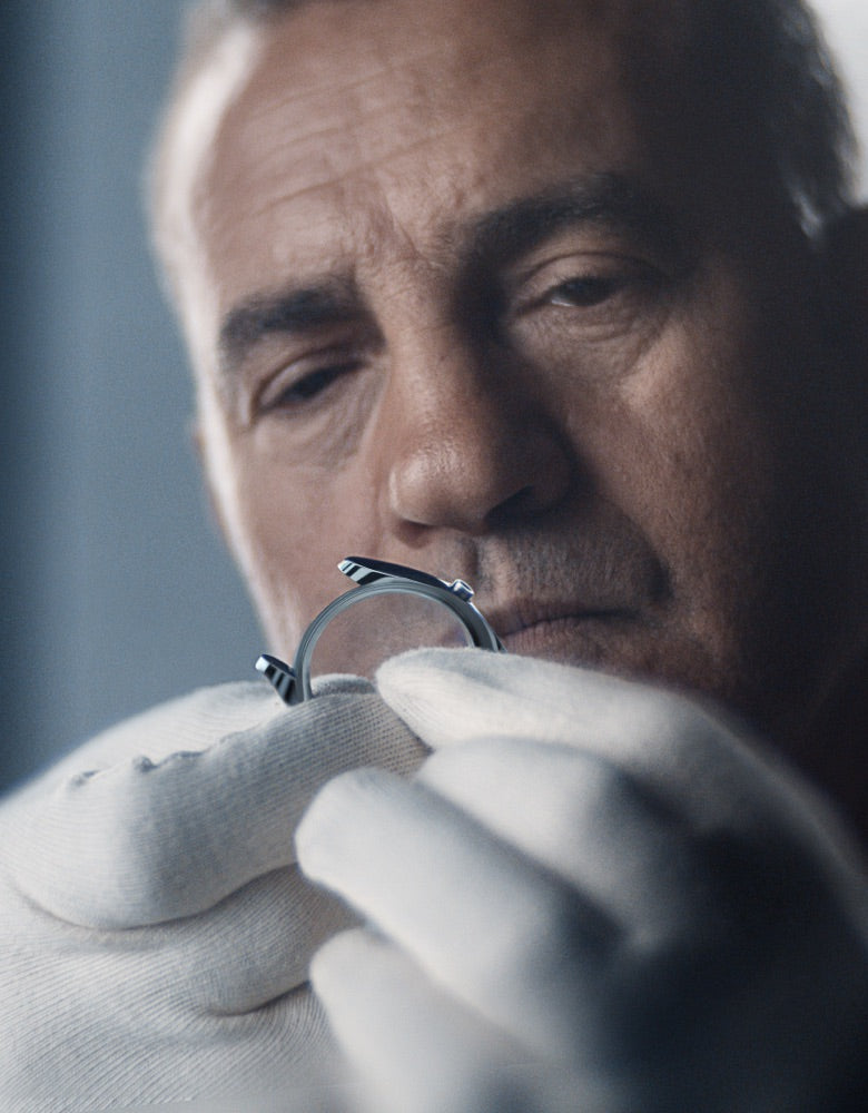 watchmaker is assessing the case landscape image portrait image