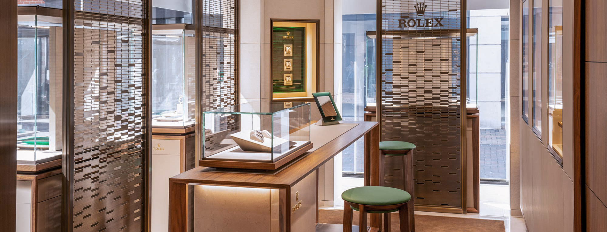 rolex at robert gatward our history, Rolex display case in a store with a chair and stool header banner for desktop