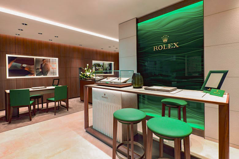 rolex at robert gatward our showrooms, Modern office interior with green chairs and a white desk cover image for mobile