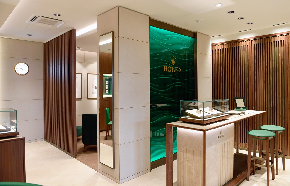 rolex at robert gatward our showroom, showing Rolex display case in our Windsor store with green and wooden accents image for desktop