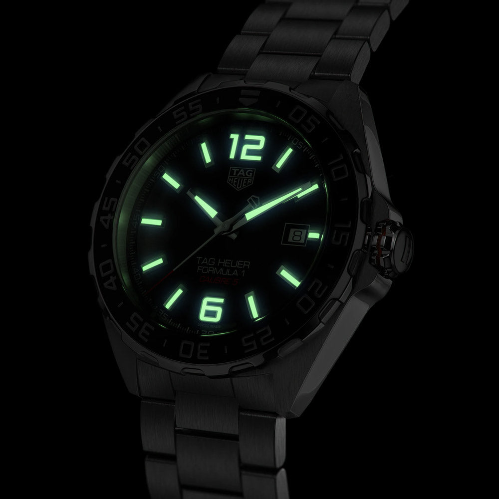 tag heuer formula 1 43mm steel and ceramic automatic watch front side facing upright in the dark image