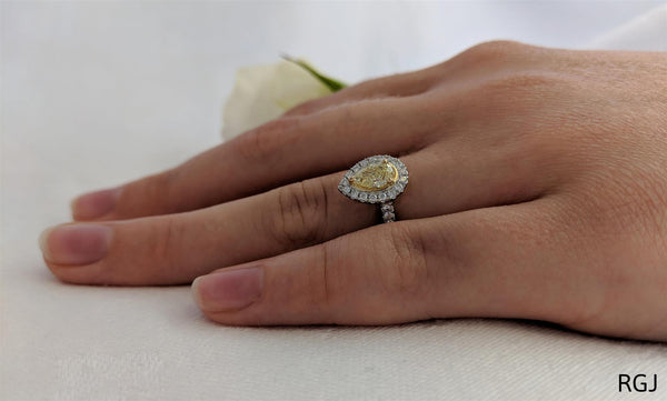 the skye platinum and 18ct yellow gold 0.39ct pear cut yellow diamond engagement ring with 0.27ct diamond halo and diamond set shoulders model shot