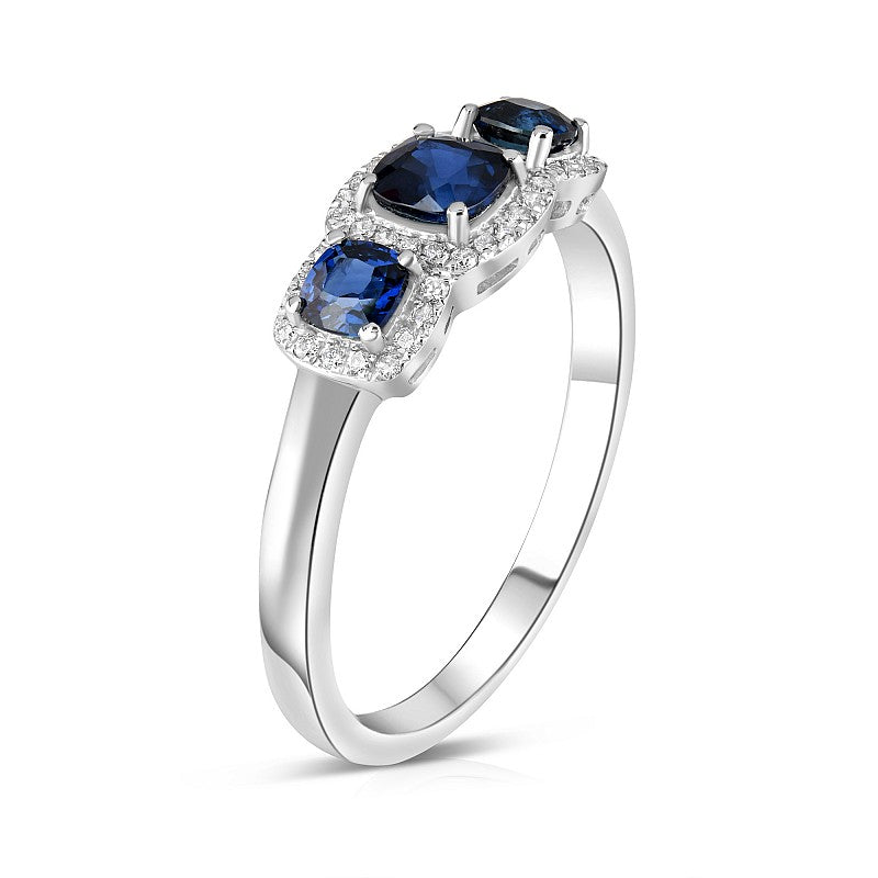 18ct White Gold 0.75ct Cushion Cut Blue Sapphire Three Stone Ring With 0.11ct Diamond Halo