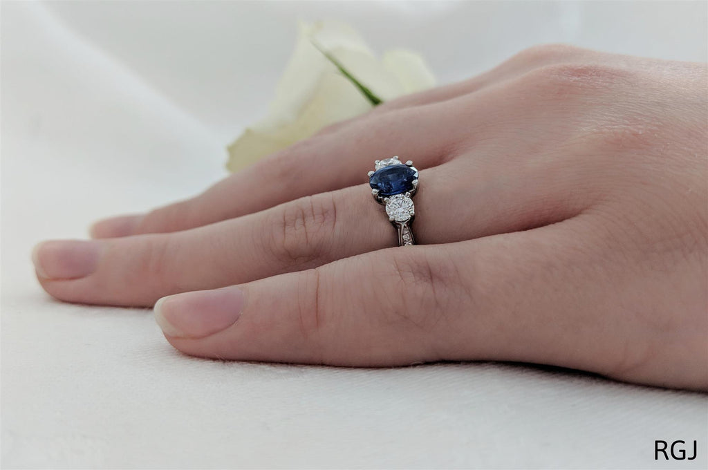 The Memoire Platinum 0.98ct Oval Cut Blue Sapphire And 0.55ct Diamond Three Stone Engagement Ring With Diamond Set Shoulders