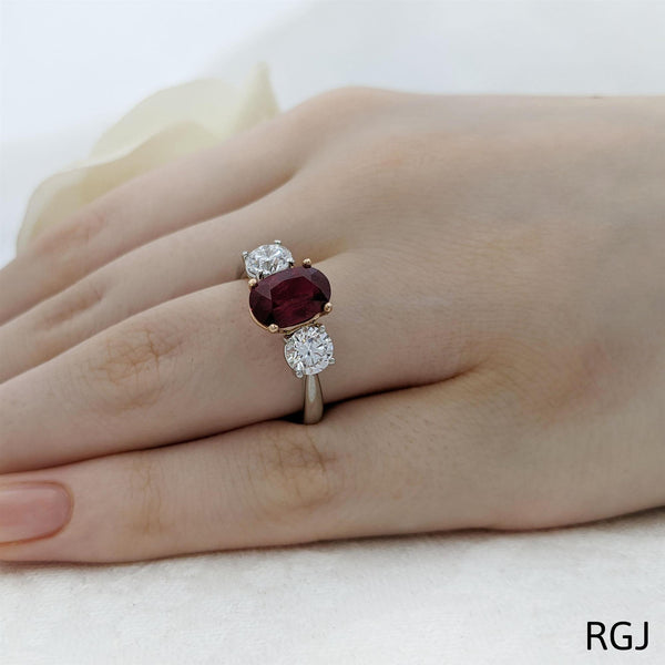 The Florentina Iconic Platinum And 18ct Rose Gold 2.04ct Oval Cut Ruby And 1.01ct Round Brilliant Cut Diamond Three Stone Ring With Diamond Detailing