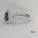 The Faroe Platinum 0.70ct Pear Cut Blue Sapphire Ring With 0.37ct Diamond Halo And Diamond Set Shoulders