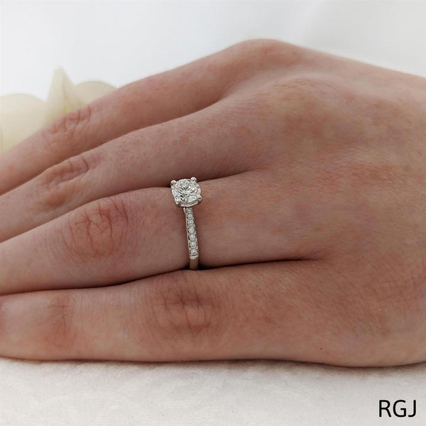 The Memoire Aura Platinum Round Brilliant Cut Diamond Solitaire Engagement Ring With Diamond Set Shoulders