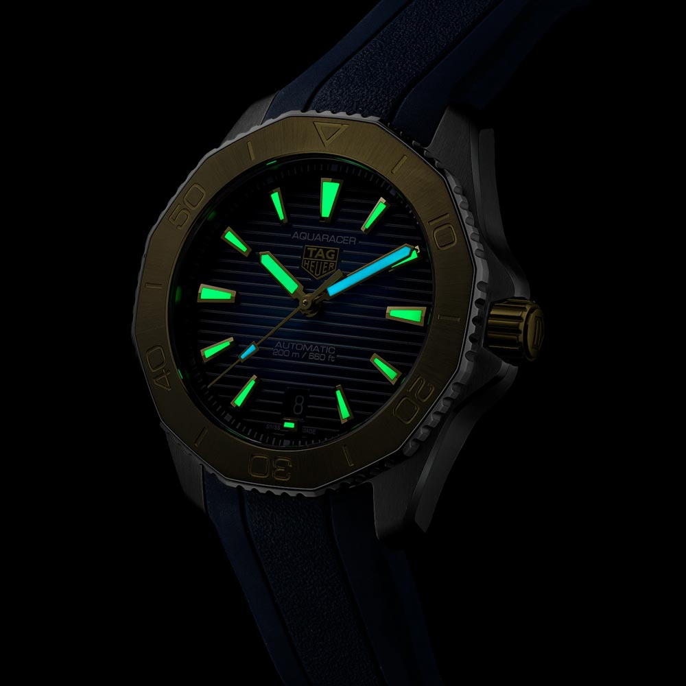 tag heuer aquaracer professional 200 blue dial 40mm steel & gold automatic gents watch in the dark shot
