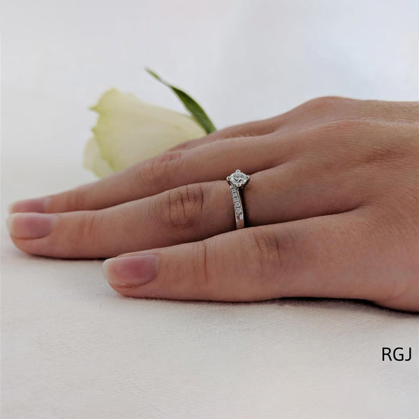 The Dursey Platinum 0.22ct Round Brilliant Cut Diamond Solitaire Engagement Ring With 0.10ct Diamond Set Shoulders