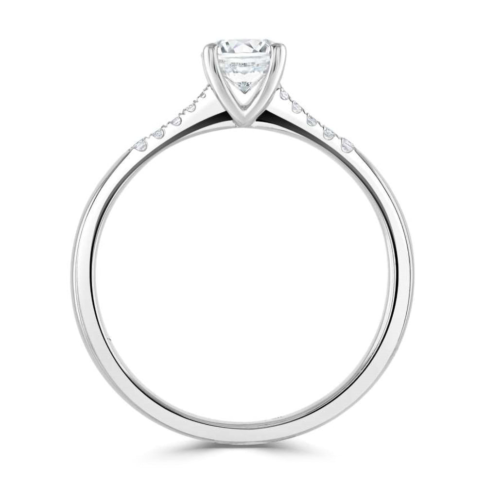 The Primula Platinum 0.30ct Round Brilliant Cut Diamond Solitaire Engagement Ring With 0.05ct Diamond Set Shoulders