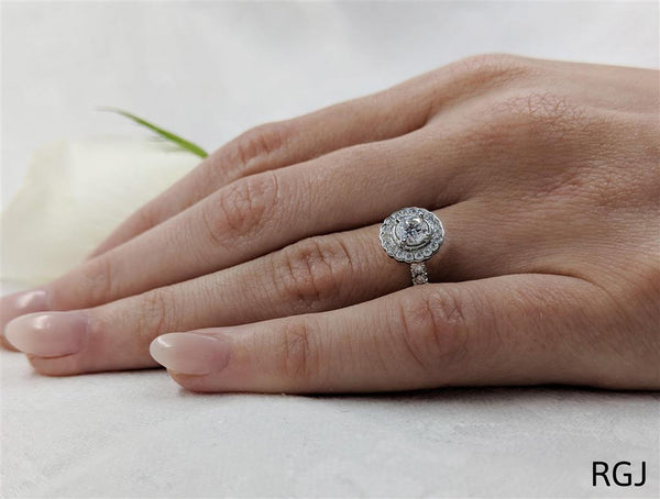 The Faroe Platinum Round Brilliant Cut Diamond Engagement Ring With Scalloped Diamond Halo And Diamond Set Shoulders