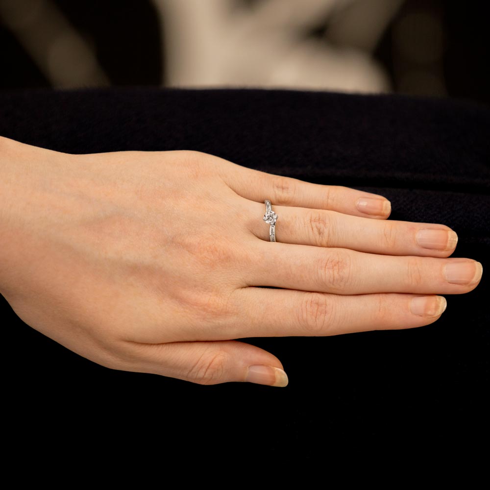 The Rose Platinum 0.40ct Round Brilliant Cut Diamond Solitaire Engagement Ring With 0.10ct Claw Set Diamond Shoulders