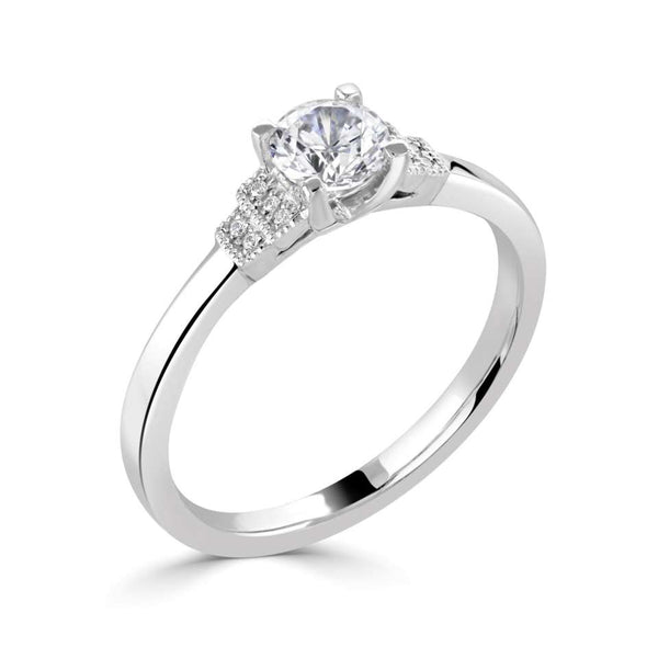 The Cornflower Platinum Round Brilliant Cut Diamond Solitaire Engagement Ring With Diamond Set Shoulders