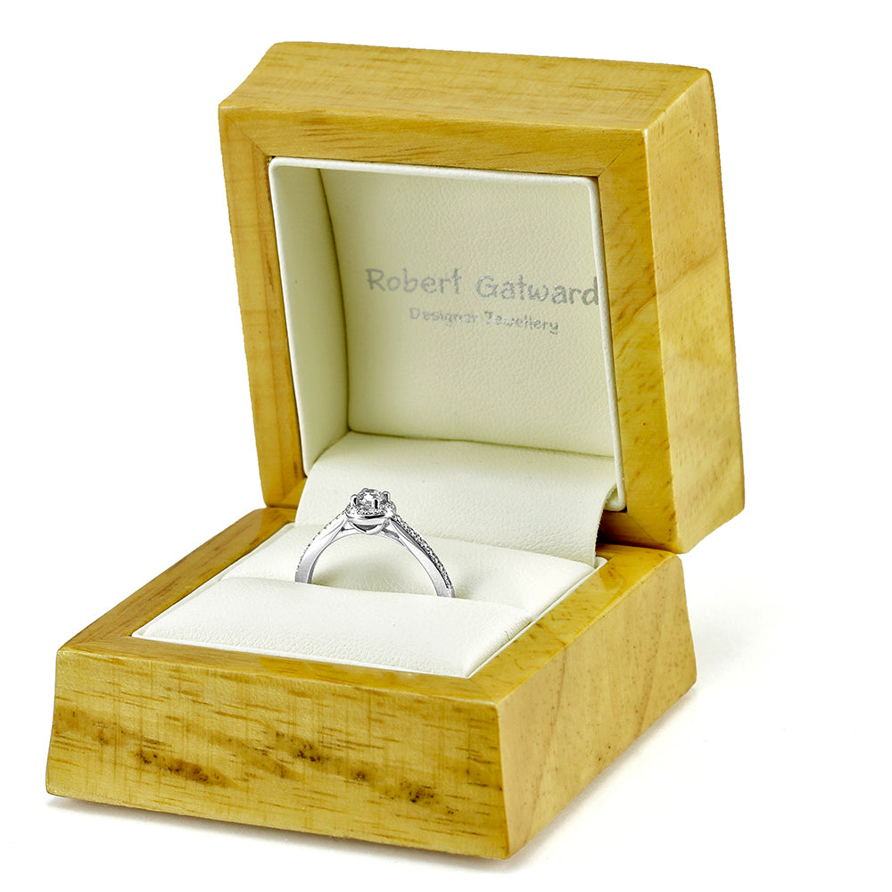 The Buttercup Platinum 0.10ct Round Brilliant Cut Diamond Halo Engagement Ring With 0.15ct Diamond Set Shoulders