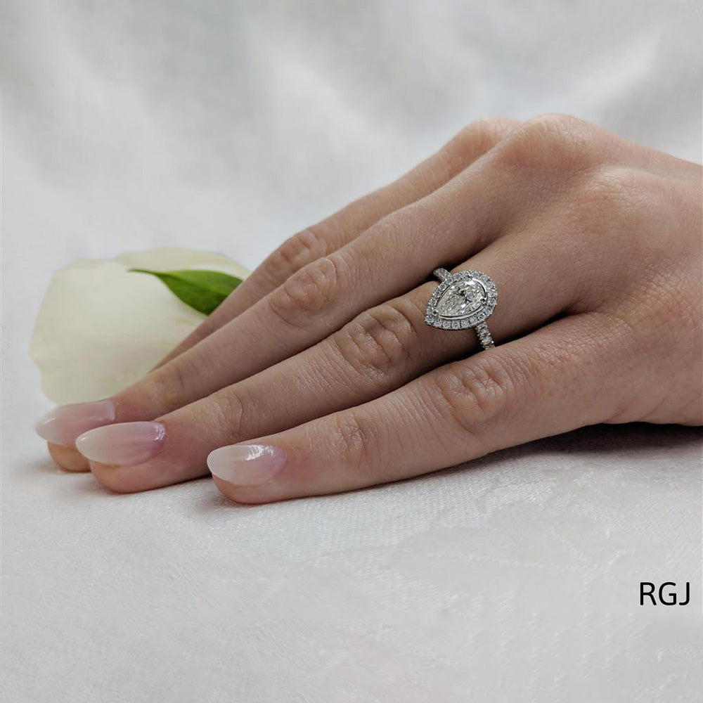 The Skye Platinum 0.70ct Pear Cut Diamond Engagement Ring With 0.39ct Diamond Halo And Diamond Set Shoulders