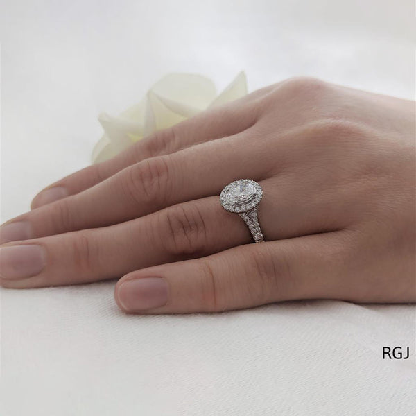 The Skye Saturn Platinum 0.51ct Oval Cut Diamond Solitaire Engagement Ring With 0.30ct Diamond Halo And Diamond Set Split Shoulders