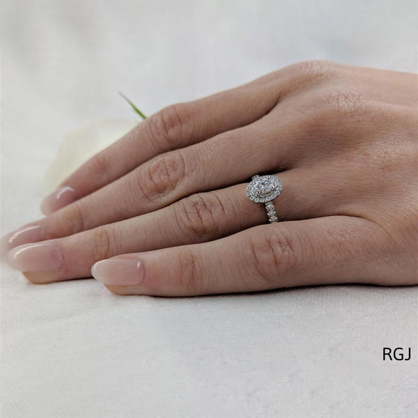 The Skye Platinum 0.30ct Oval Cut Diamond Engagement Ring With 0.27ct Diamond Halo And Diamond Set Shoulders