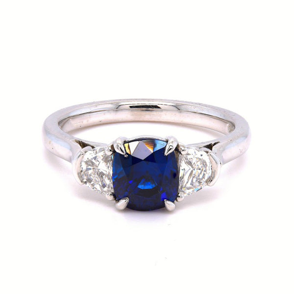 Platinum 2.87ct Oval Cut Blue Sapphire And 0.93ct Crescent Diamond Three Stone Ring