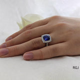 The Evie Platinum 2.11ct Cushion Cut Blue Sapphire Ring With 0.57ct Diamond Halo And Diamond Set Shoulders