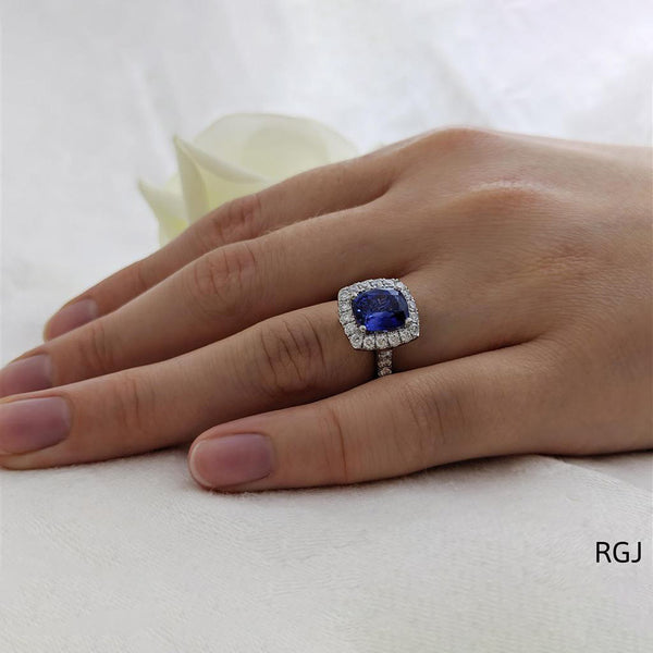 The Evie Platinum 2.11ct Cushion Cut Blue Sapphire Ring With 0.57ct Diamond Halo And Diamond Set Shoulders