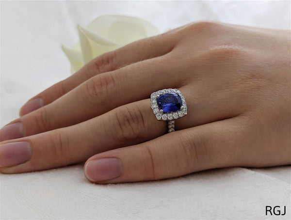 The Evie Platinum 2.11ct Cushion Cut Blue Sapphire Ring With 0.57ct Diamond Halo And Diamond Set Shoulders