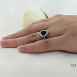 The Skye Platinum 0.74ct Oval Cut Blue Sapphire Ring With 0.35ct Diamond Halo And Diamond Set Shoulders
