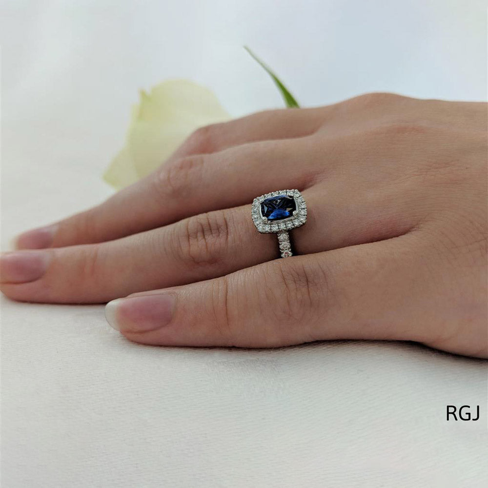The Skye Platinum 0.67ct Cushion Cut Blue Sapphire Ring With 0.36ct Diamond Halo And Diamond Set Shoulders