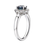 18ct White Gold 1.05ct Oval Cut Blue Sapphire And 0.42ct Round Brilliant Cut Diamond Cluster Ring
