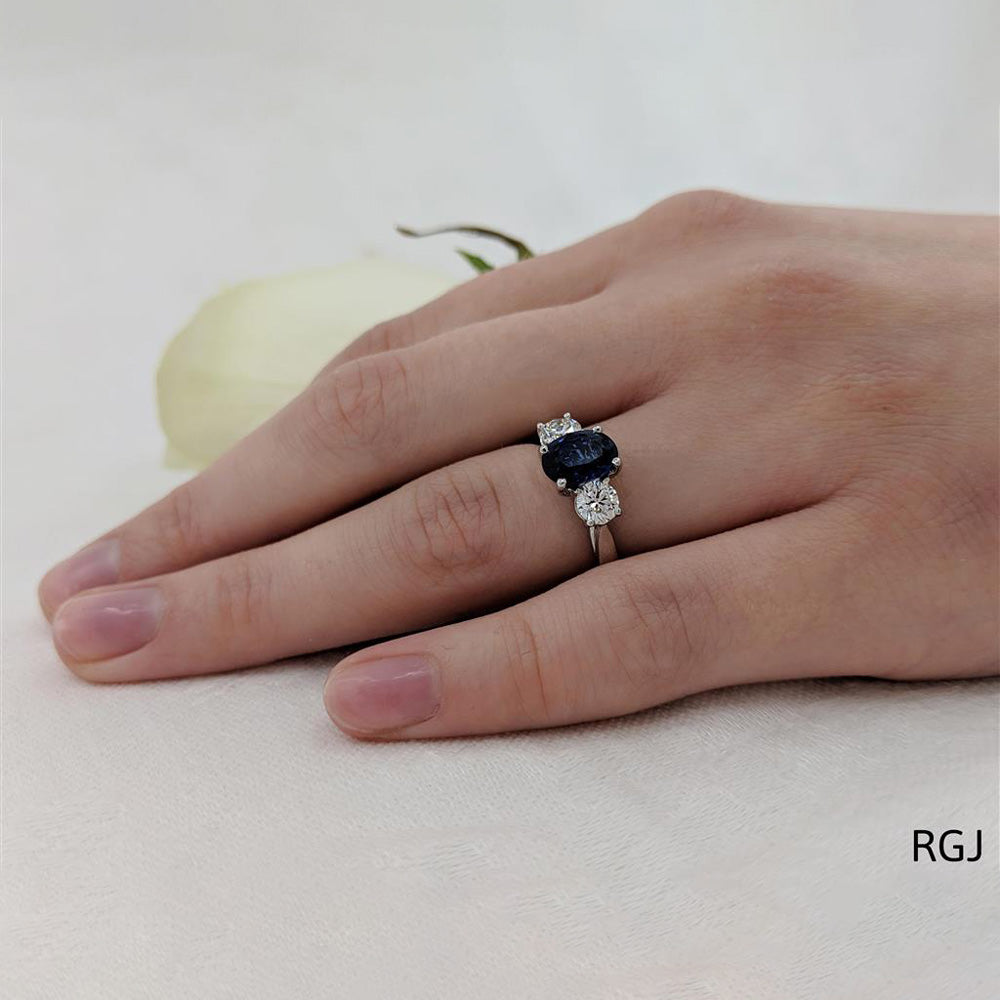 The Royal Platinum 1.48ct Oval Cut Blue Sapphire And 0.58ct Round Brilliant Cut Diamond Three Stone Ring