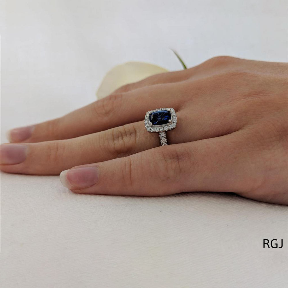 The Skye Platinum 1.81ct Cushion Cut Blue Sapphire Ring With 0.43ct Diamond Halo And Diamond Set Shoulders