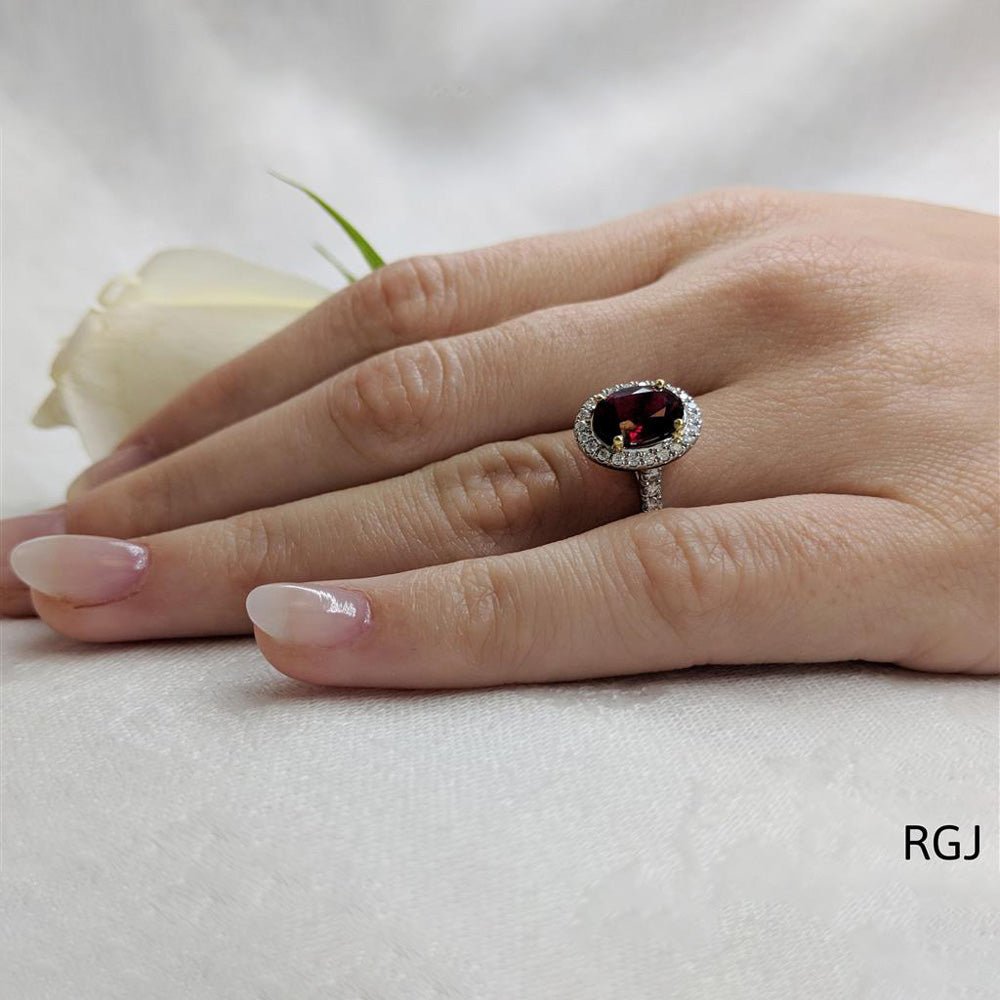 The Skye Platinum 2.13ct Oval Cut Ruby Ring With 0.42ct Diamond Halo And Diamond Set Shoulders