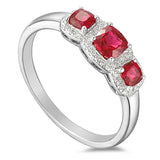 18ct White Gold 0.65ct Cushion Cut Ruby Three Stone Ring With 0.11ct Diamond Halo
