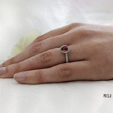 The Skye Platinum 0.75ct Pear Cut Ruby Ring With 0.39ct Diamond Halo And Diamond Set Shoulders