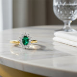 18ct Yellow And White Gold 0.32ct Oval Cut Emerald And 0.29ct Round Brilliant Cut Diamond Cluster Ring