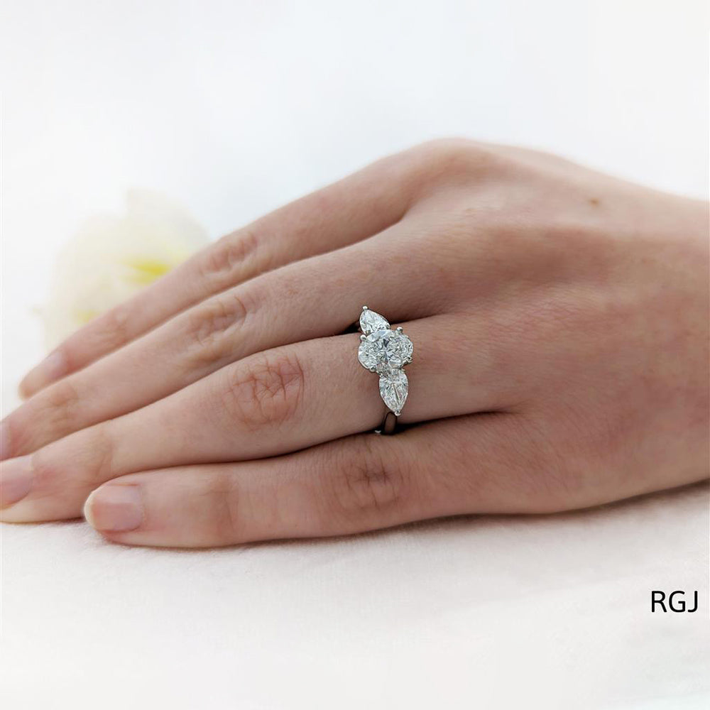 Platinum 1.04ct Oval And 0.62ct Pear Cut Laboratory Grown Diamond Three Stone Engagement Ring