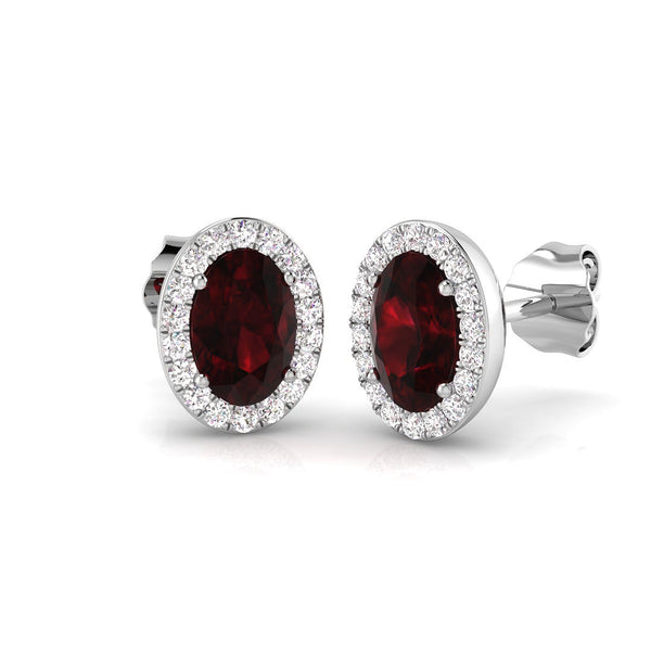 18ct White Gold 1.09ct Oval Cut Ruby And 0.19ct Diamond Halo Stud Earrings